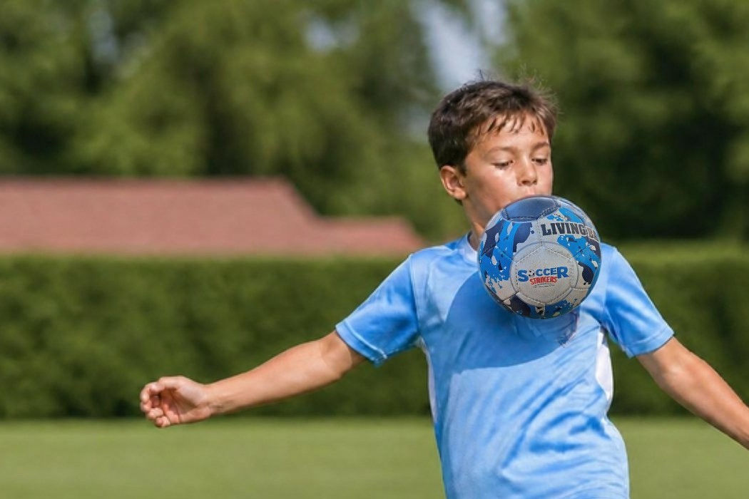 A young Soccer Strikers player controlling the ball at a school soccer lesson